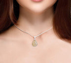 Necklace with a teardrop-shaped pendant worn by a person